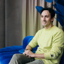 Daniel Motino sitting on a blue sofa
