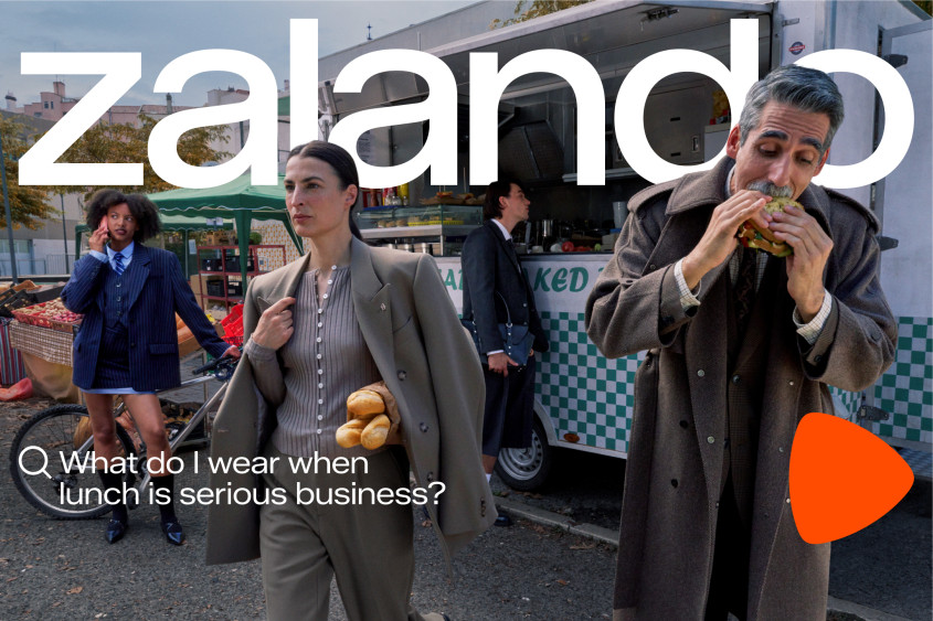 People stand and eat at a marketplace for our Autumn Winter campaign 2025