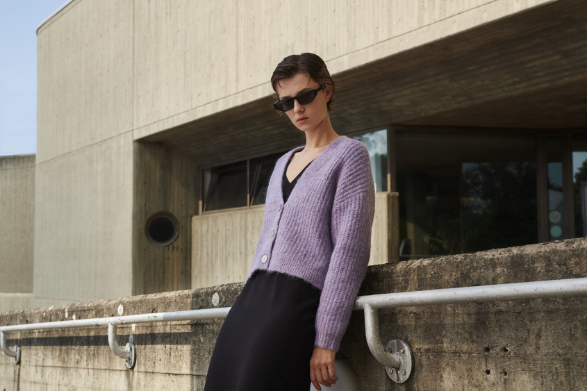 A woman wearing sunglasses looking into the camera
