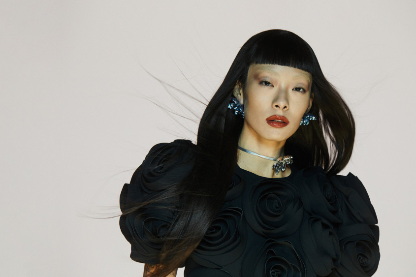 Rina Sawayama in a black outfit and a silver necklace for Zalando