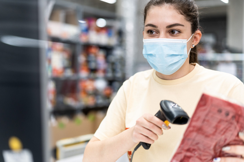 Female logistics employee scanning a product