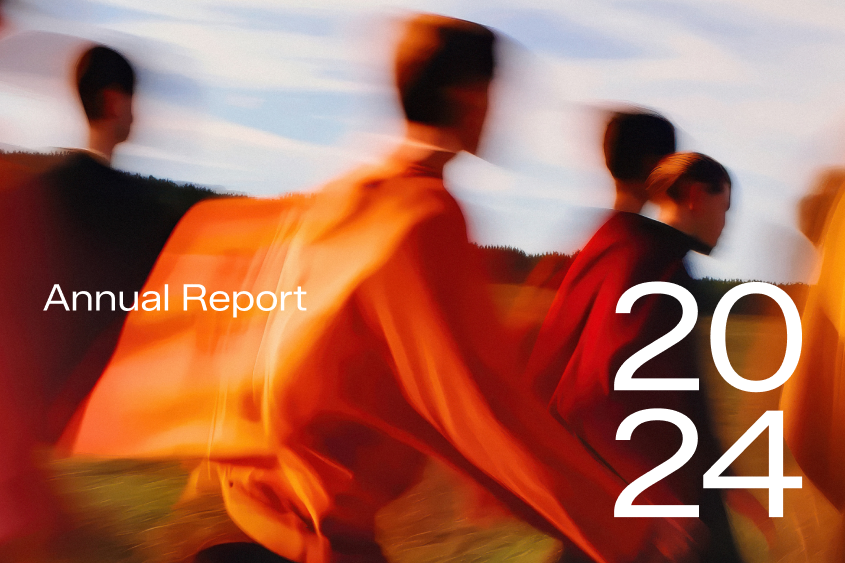 Annual Report 2024 - blurry background image showing a group of people walking in the golden light of low sun