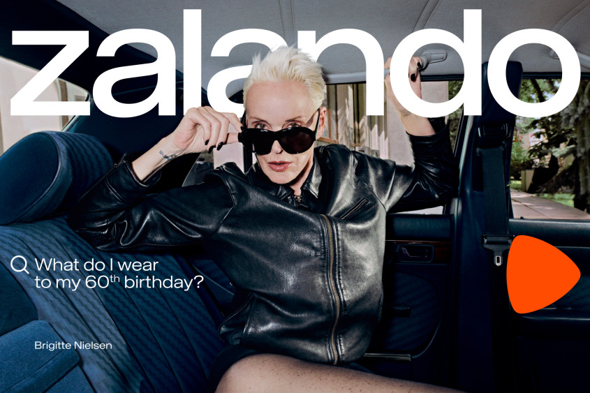 Brigitte Nielsen inside a car; she is wearing a revealing black outfit and looking at the viewer over the top of black sunglasses; big Zalando wordmark; the copy reads: What do I wear to my 60th birthday