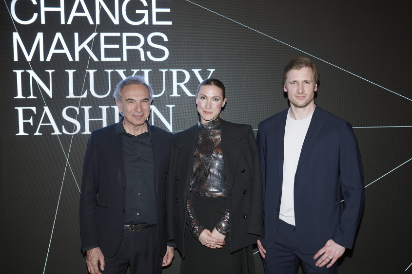 Three people in fron of a Change Makers in luxury fashion backdrop