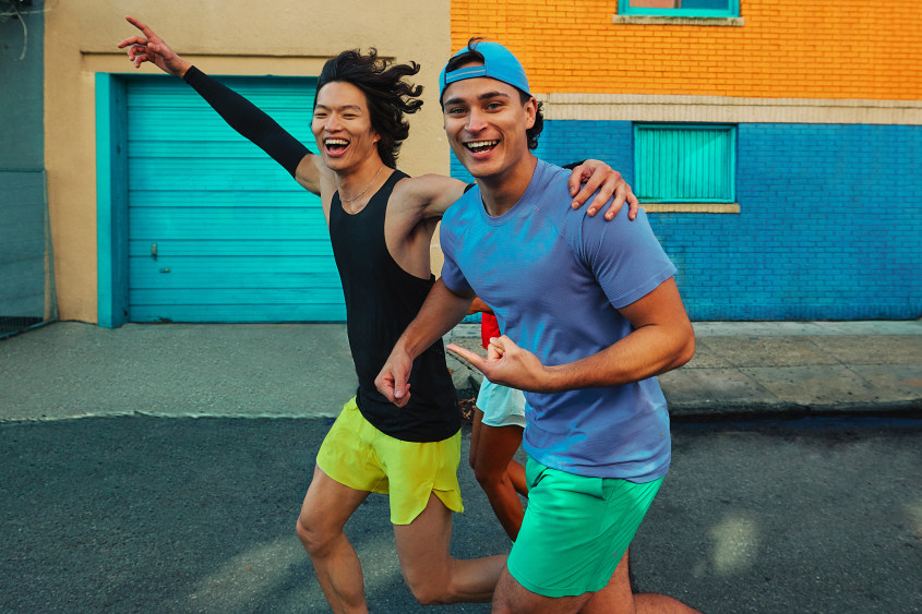 Two runners in colourful sportswear laughing at the camera