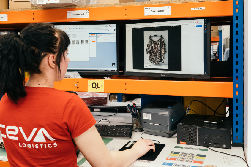 A CEVA employee looks at a monitor about a returned item.