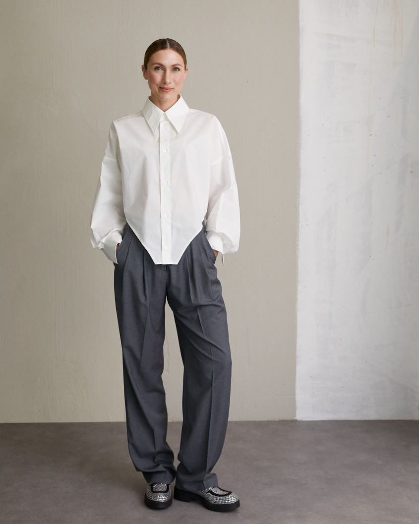 Portrait of Lena-Sophie Roeper in a white button-down and elegant grey trousers