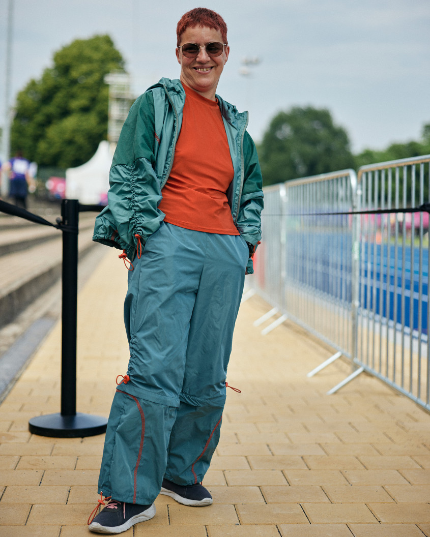 Female athlete wearing sunglasses presenting casual sportswear to the camera