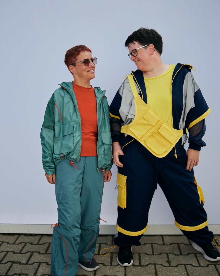 Two female athlete in casual sportswear smiling at each other