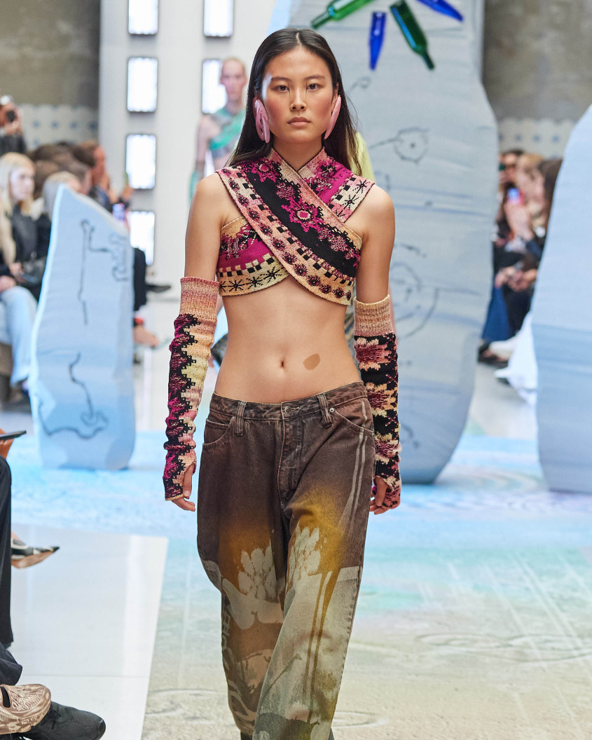 Fashion model on the runway; wlaking directly towards the camera