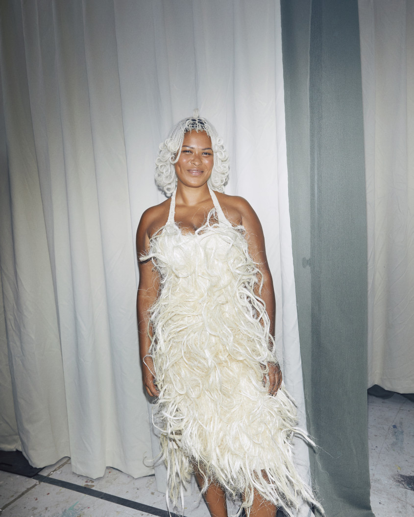 Fashion model backstage wearing a white furry dress
