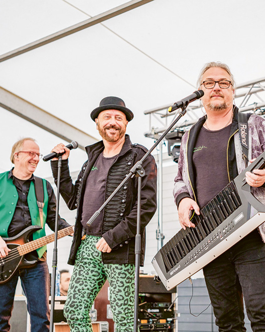 A band of three men on stage