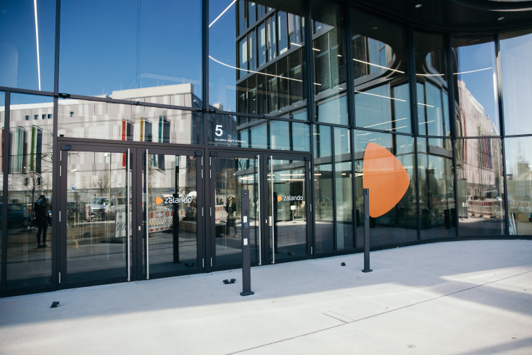 Entrance of Zalando Headquarter, other buildings are mirrored in the glass facade