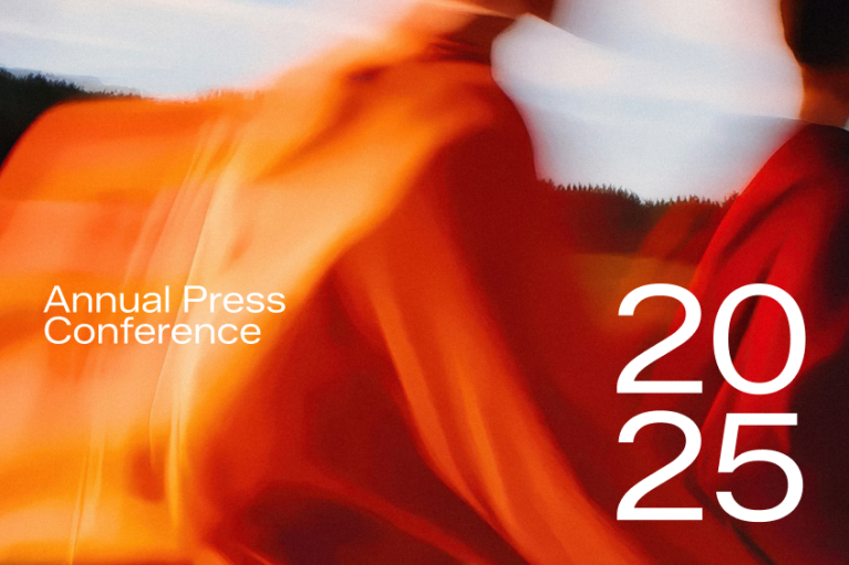 Annual Press Conference 2025 - blurry background image showing a group of people walking in the golden light of low sun