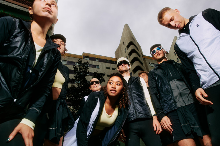 A group of people in streetwear standing in a semicircle 