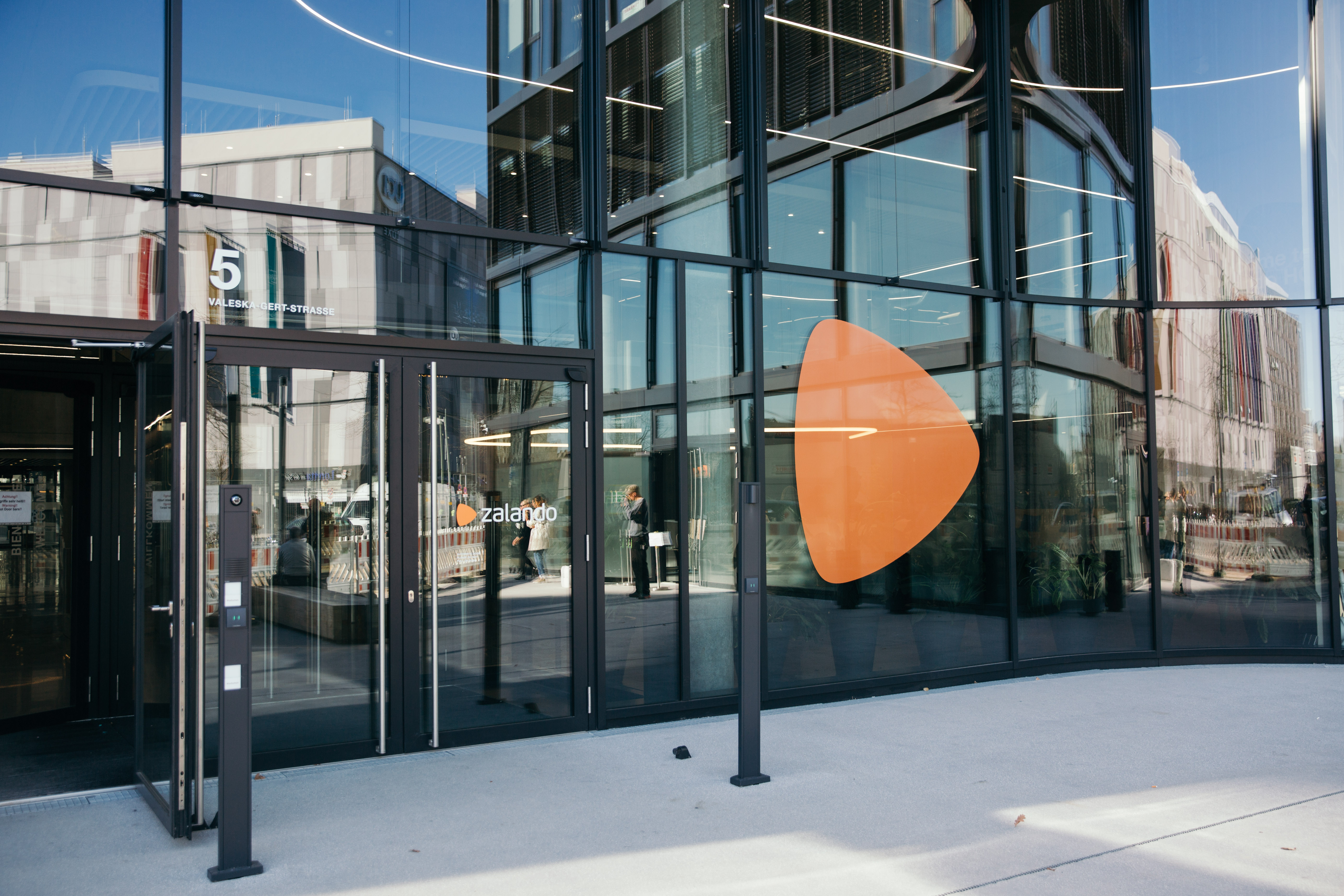 Entrance of Zalando Headquarter, other buildings are mirrored in the glass facade