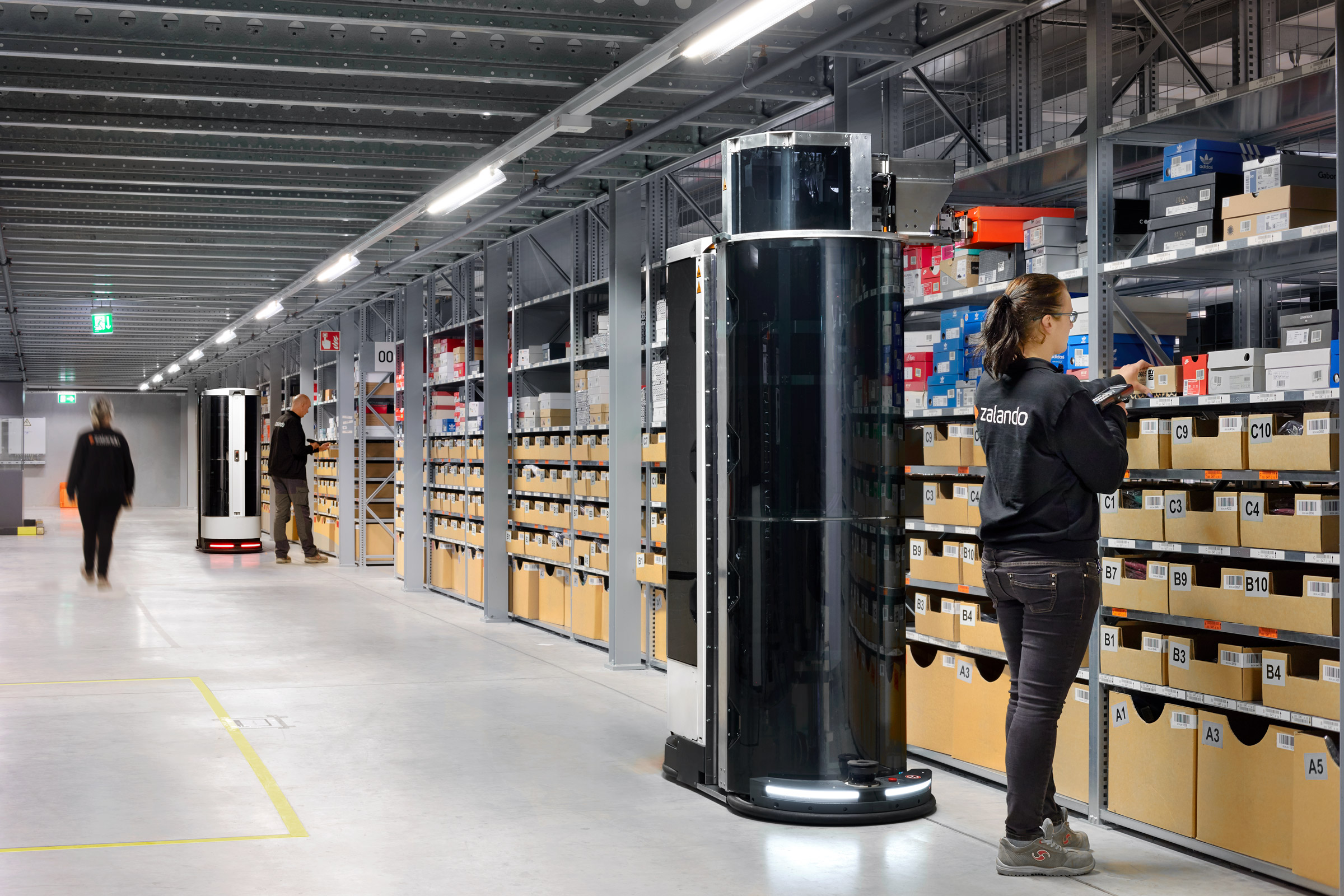 Zalando warehouse with employees working alongside mobile robots