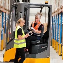 Two female logistics workers in a warehouse setting
