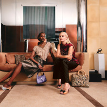 Two women lounging on a designer sofa