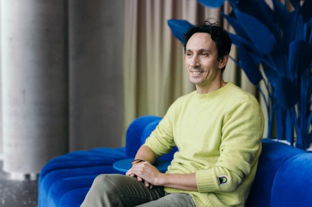 Daniel Motino sitting on a blue sofa