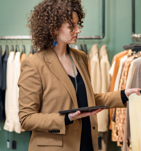 A woman looks at clothes in a shop