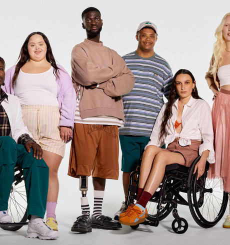 Six people modelling adaptive fashion; two of them are sitting in a wheelchair, two have visible prosthetic legs