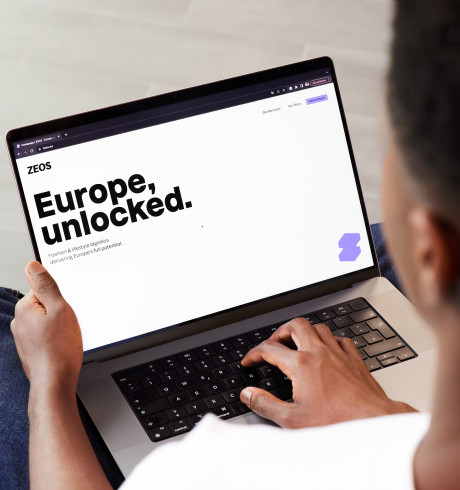 Person with open laptop; on screen it reads: Europe unlocked