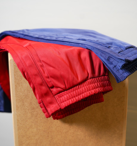 red and blue trousers with buttons on the side