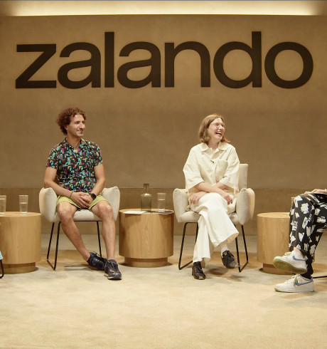 Four people during a panel discussion; the Zalando logo in the background