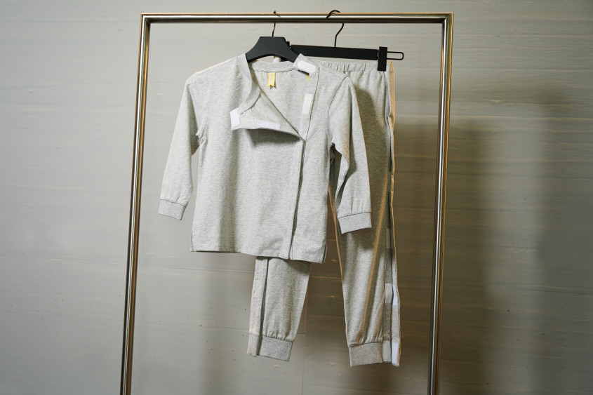 grey shirt and trousers with hook-and-loop fasteners openings at the sides