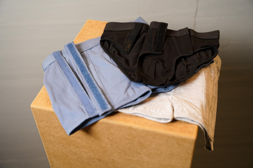 light blue, grey and black underwear with hook-and-loop fasteners openings at the front