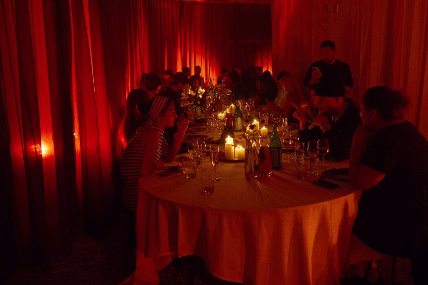 Dinner in a very low-lit room, candles on the table