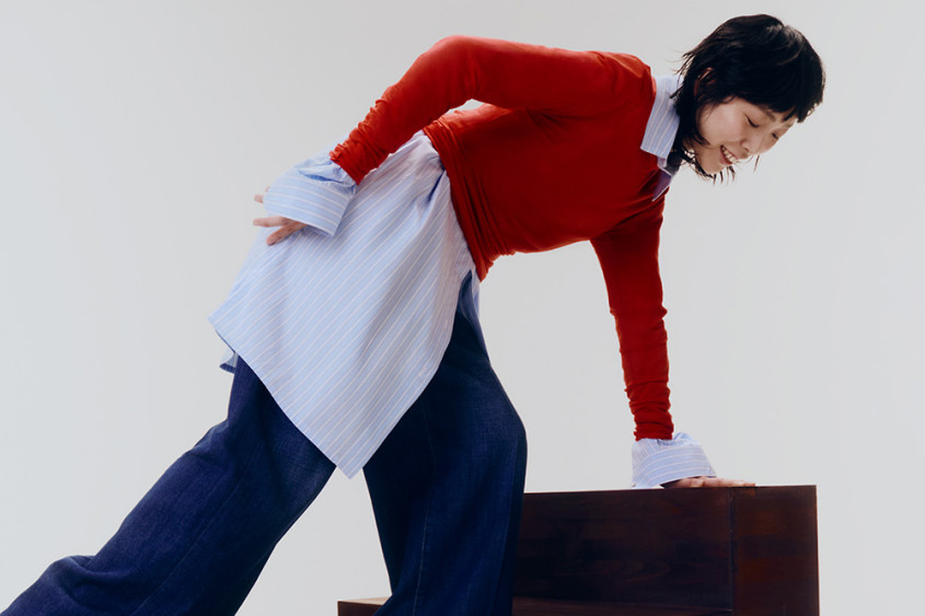 A female model posing dynamically on some steps
