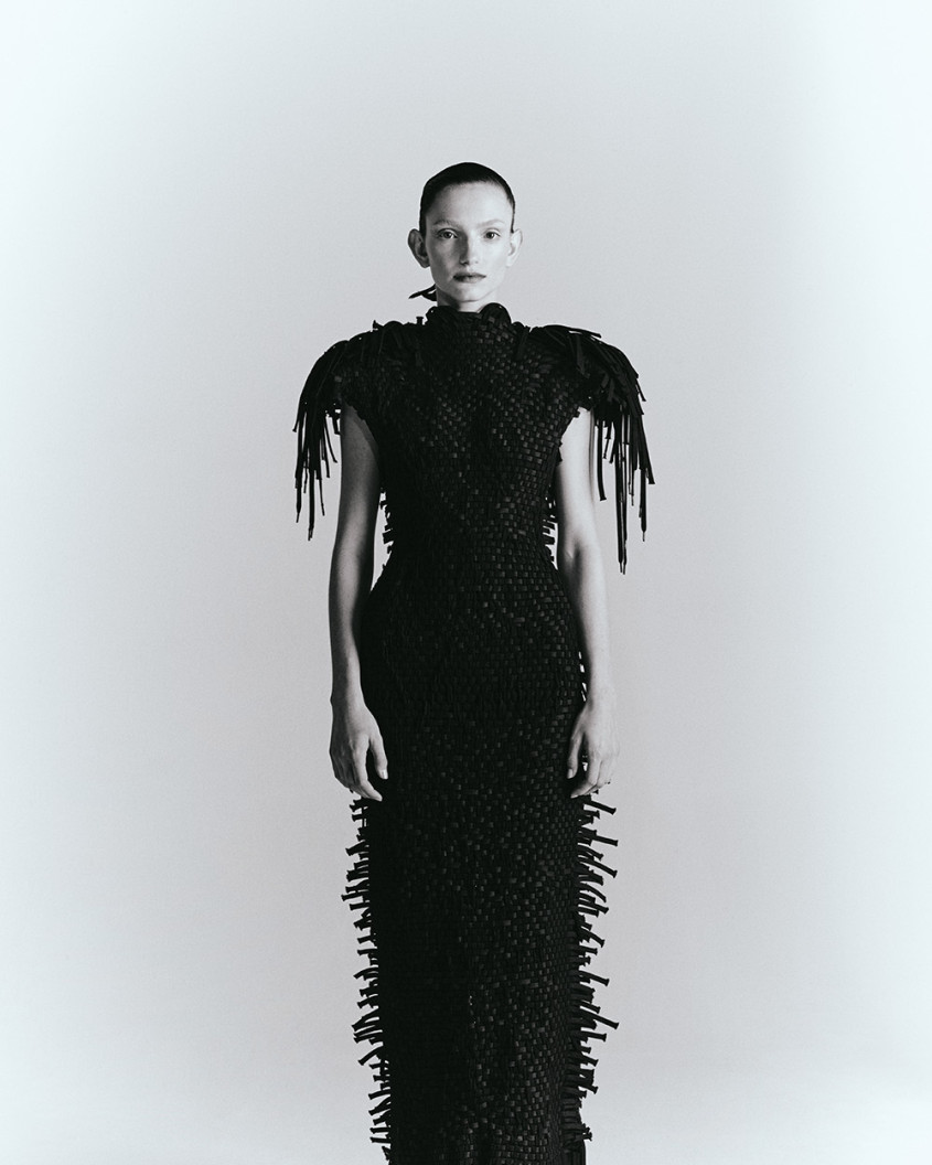 Monochrome picture of a fashion model wearing a long black dress