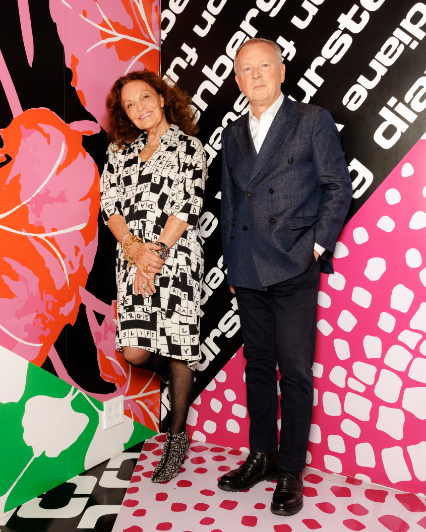 Diane von Furstenberg and Graziano De Boni posing in front of a very colourful backsplash