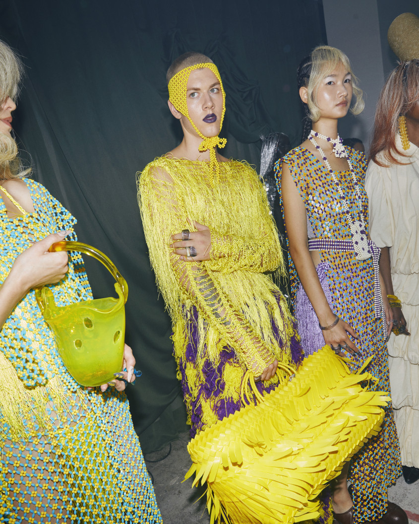 Fashion model in a yellow outfit with big bag