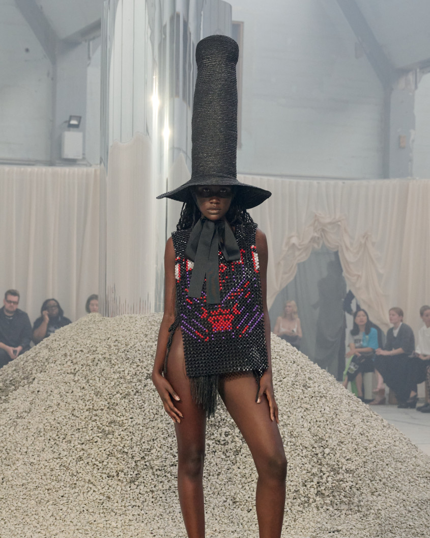 Fashion model wearing a very tall black hat