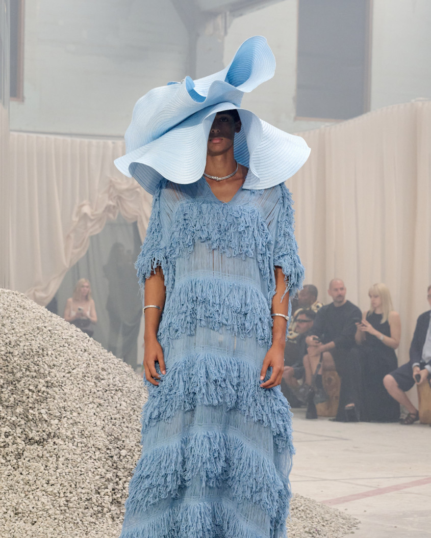 Fashion model wearing a huge blue floppy hat and blue dress