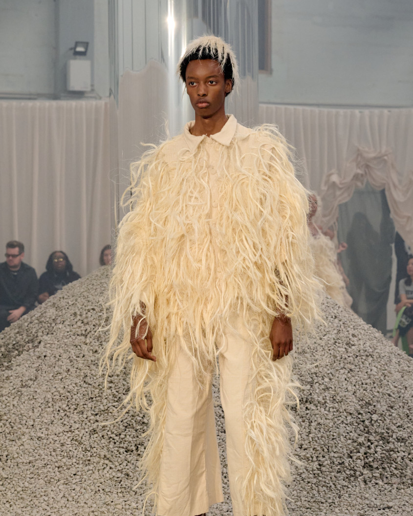 Fashion model in a big white furry suit