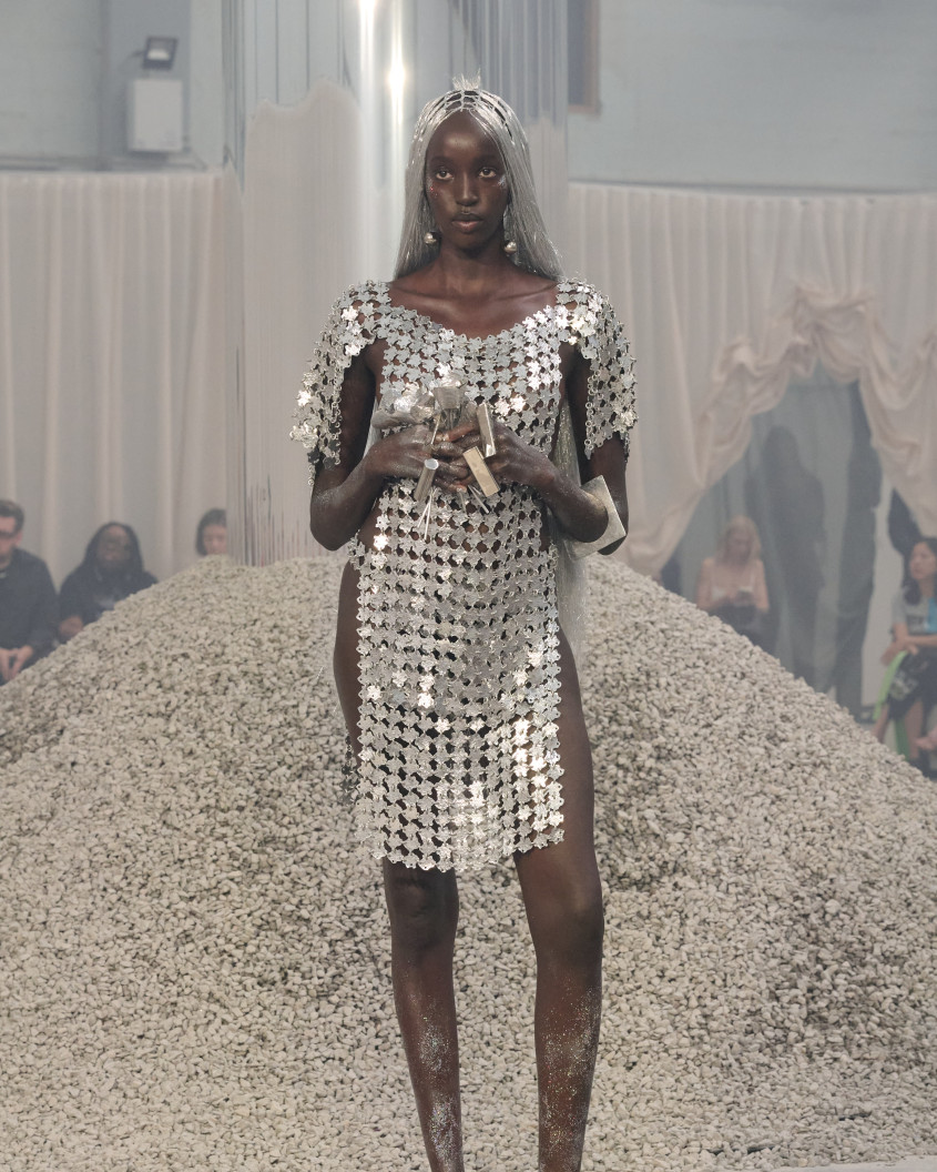 Fashion model wearing a silver wig and chainmail dress
