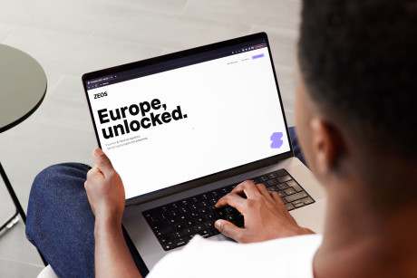 Person with open laptop; on screen it reads: Europe unlocked