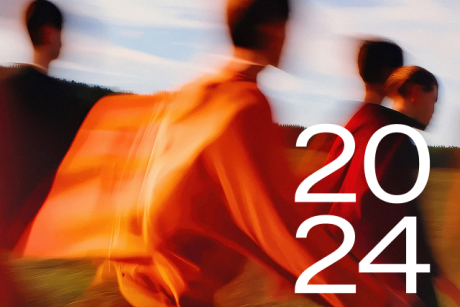 2024 - blurry background image showing a group of people walking in the golden light of low sun