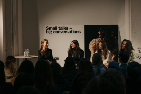 Four women during a panel discussion; the backdrop reads: Small talks - big conversation
