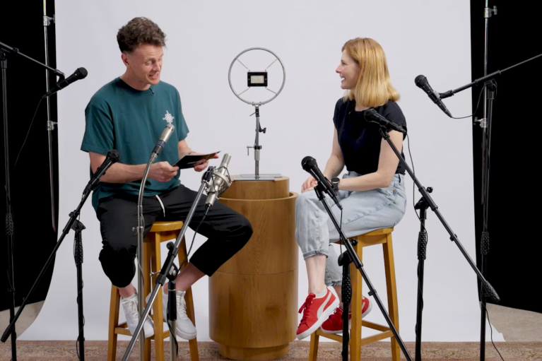 The two people in conversation sitting in the recording studio