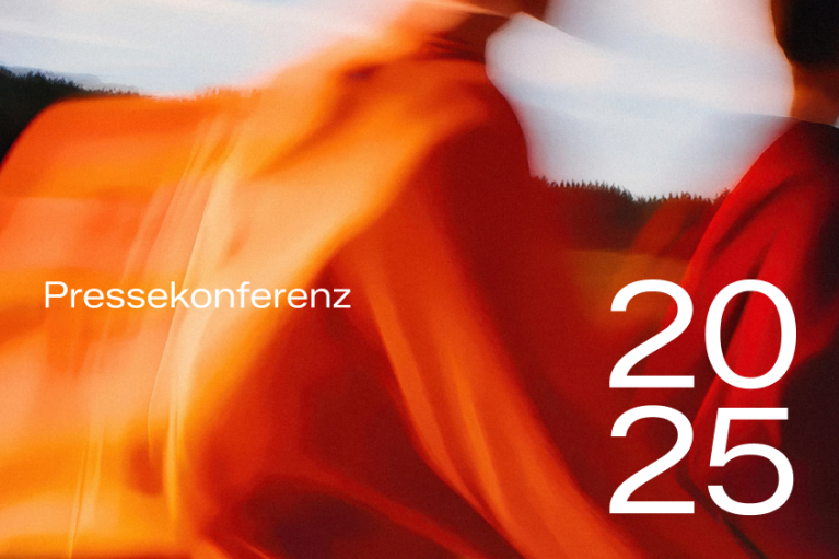 Pressekonferenz 2025 - verschwommenes Hintergrundbild zeigt eine laufende Gruppe von Personen im goldenen Abendlicht