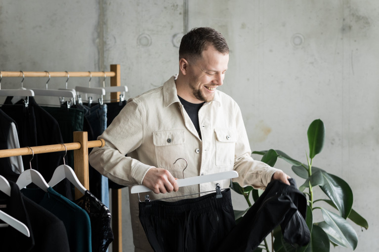 Philip Hammermeister putting clothes on a hanger