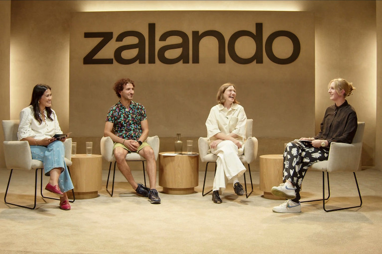 Four people during a panel discussion; the Zalando logo in the background